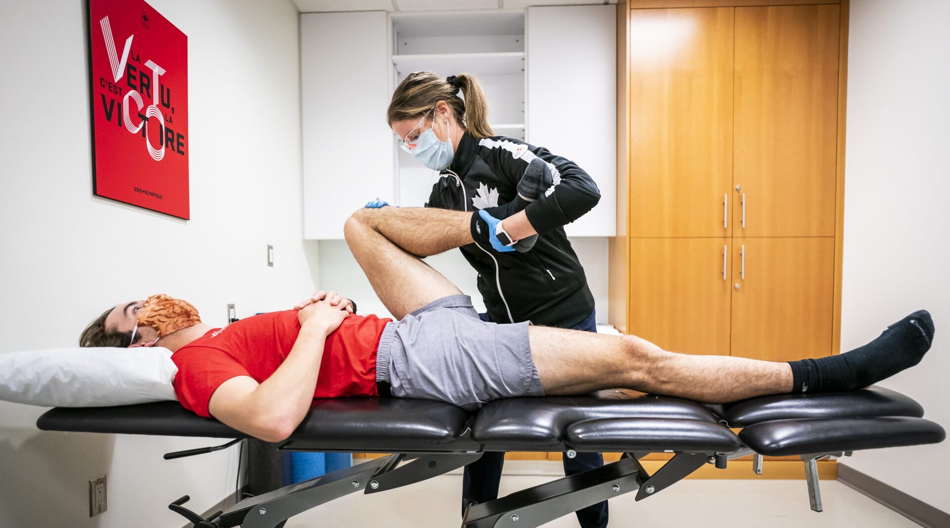 Speed Skater Jake Weidemann works with physiotherapist Lauren Vickery at the Canadian Sport Institute Calgary facilities in Calgary, Alberta on April 28, 2021.